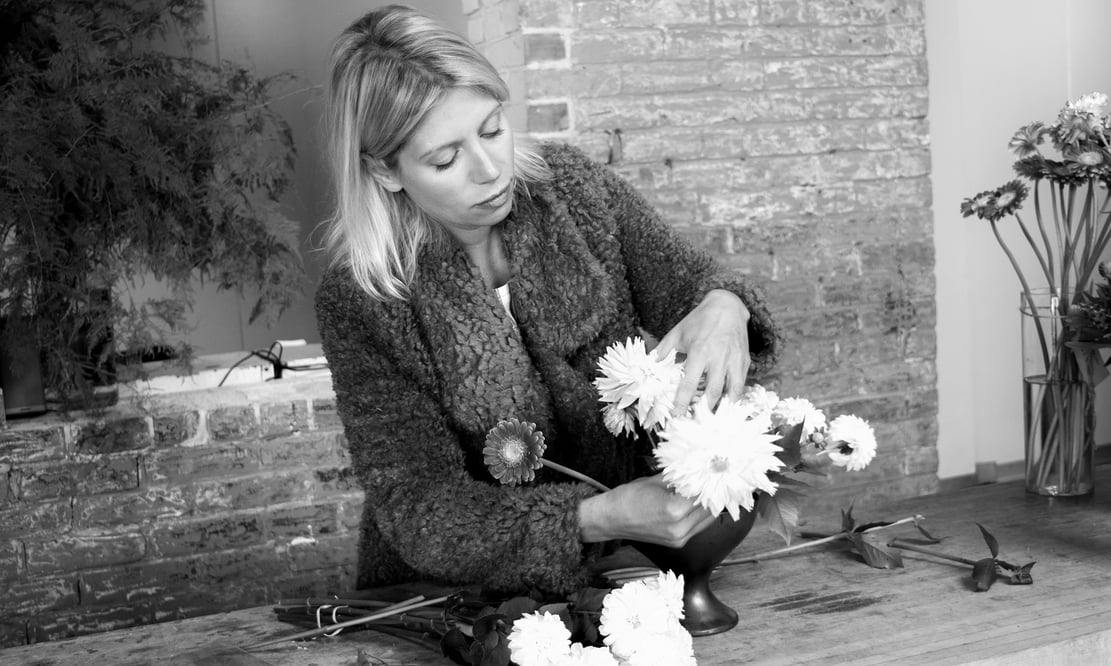 Semia Dunne of Flowers by Semia, arranging in her design studio