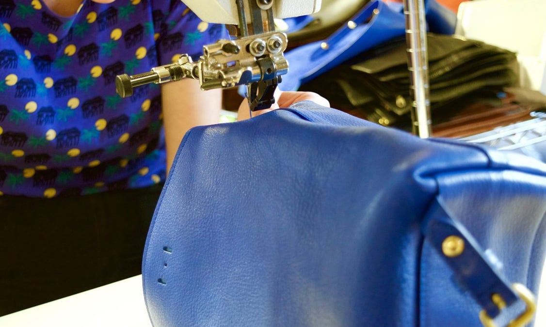 Stitching the Lotuff Leather Mini Sling backpack in electric blue