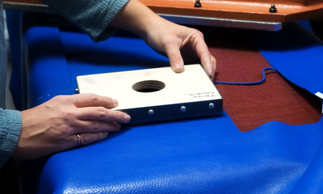 Cutting the Lotuff Leather Tripp handbag in electric blue