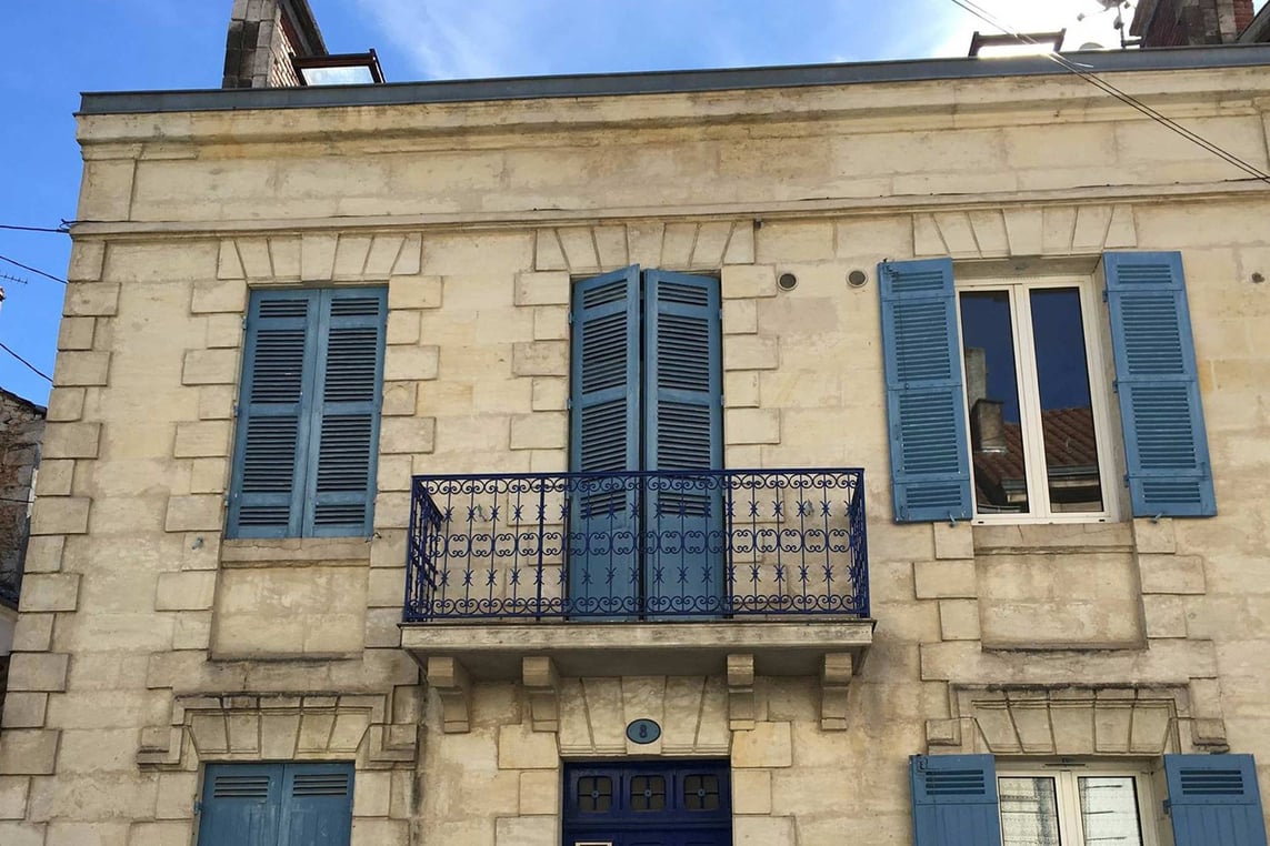 Balconies and blue shutters in Perigueux, France