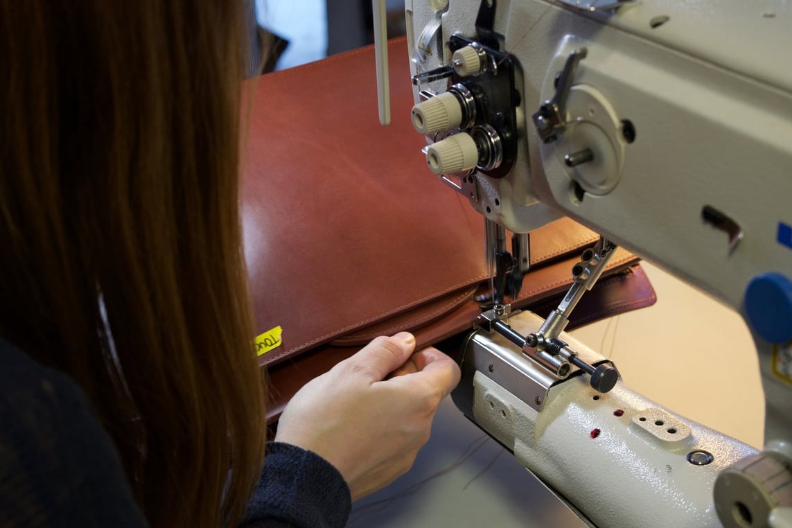 Stitching the Lotuff Leather Wells Briefcase in cognac bridle