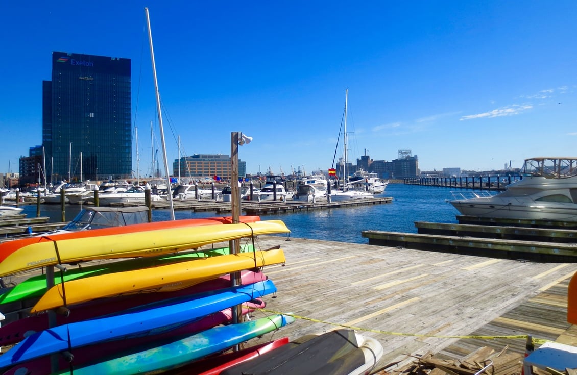 Kayaks stacked near the water in Baltimore's Inner Harbor