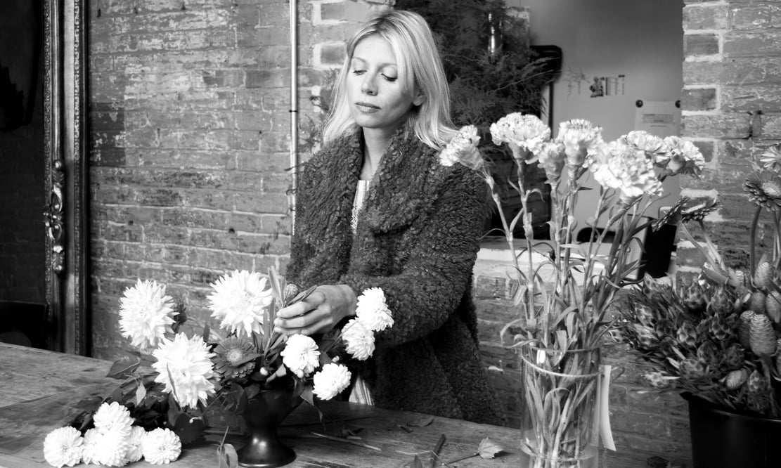 Semia Dunne of Flowers by Semia, arranging in her design studio