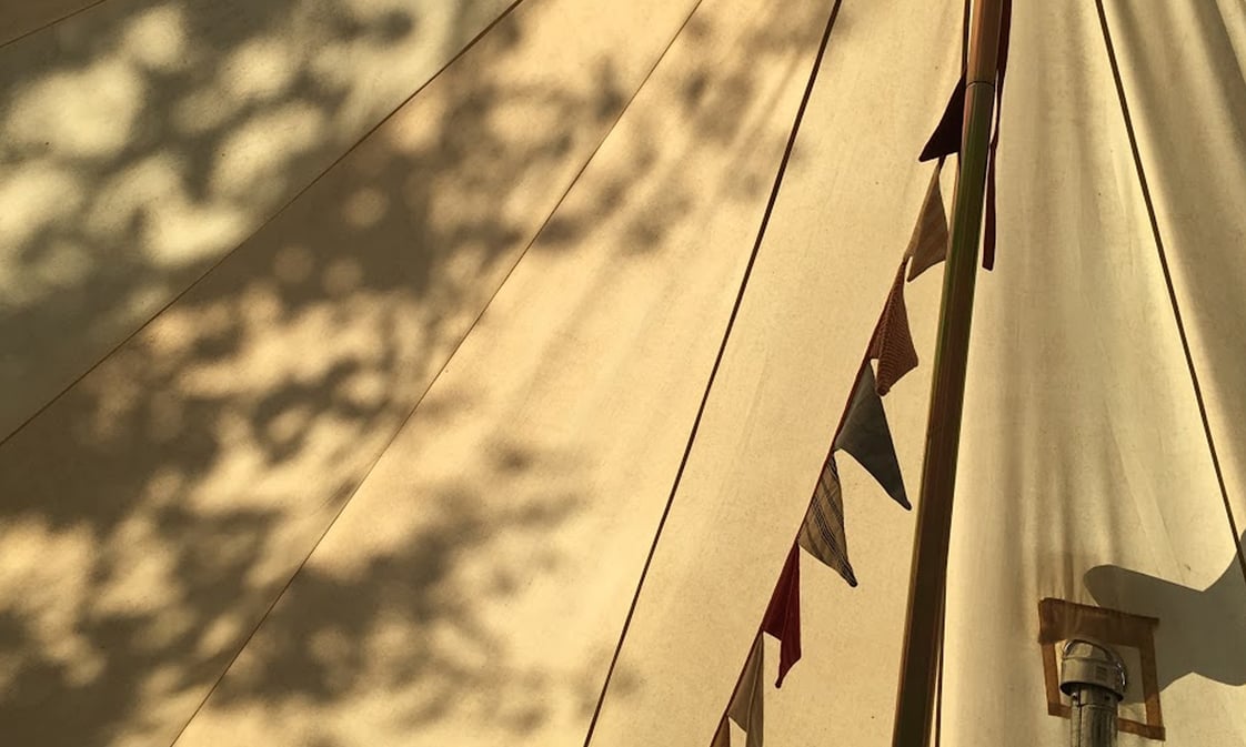 Interior of a Gatherwild yurt, bunting included