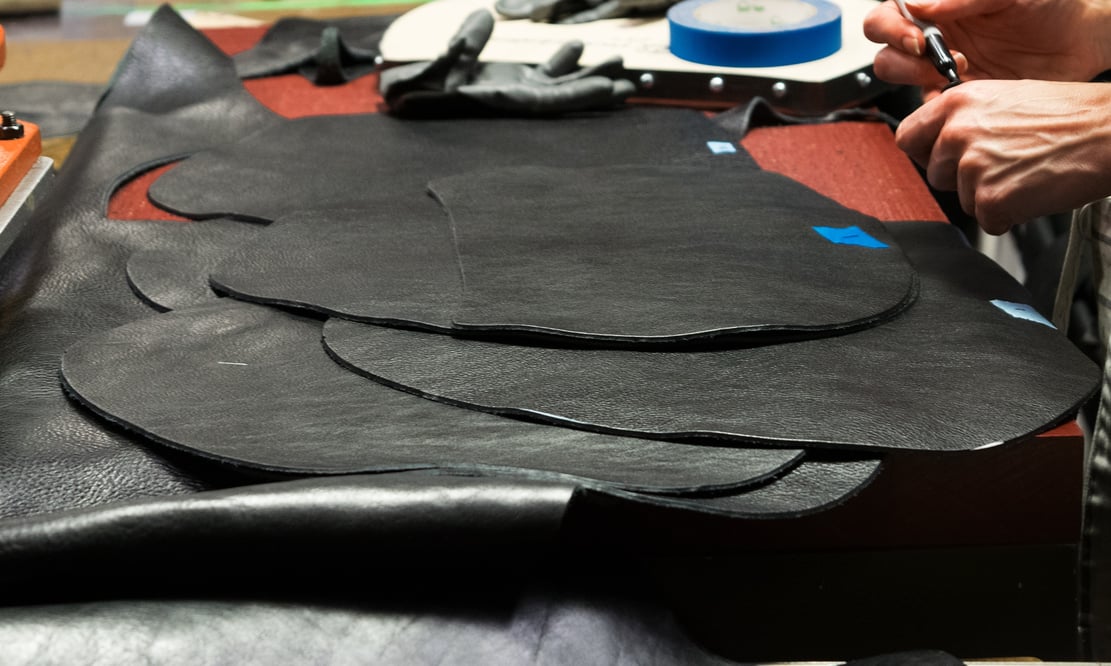 Cutting the Lotuff Leather Rho handbag in black