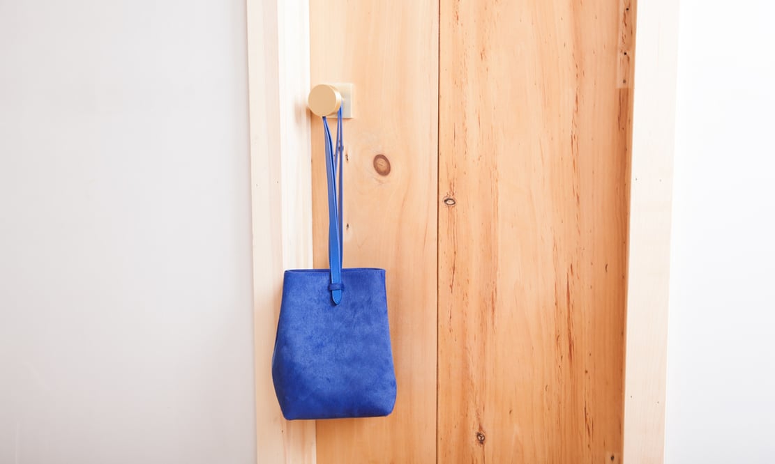 Schoolhouse Electric Berlin Door Set with Cylinder Knob, accompanied by a Lotuff Leather Sling backpack in electric blue calf hair Schoolhouse Electric Berlin Door Set with Cylinder Knob, accompanied by a Lotuff Leather Sling backpack in electric blue calf hair