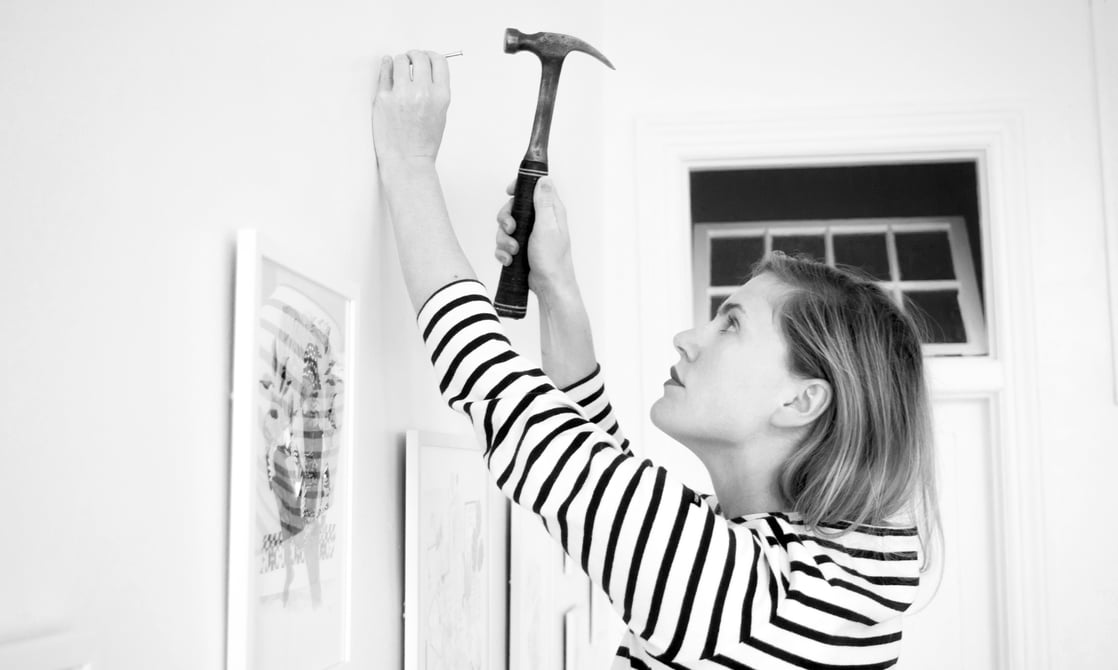 Willa Van Nostrand hanging some of Priscilla Weidlein's art in her gallery